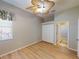 Bedroom featuring light-colored wood floors, ceiling fan and window with blinds at 421 Marsh Creek Rd, Venice, FL 34292