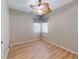 Bedroom featuring light-colored wood floors and window with blinds at 421 Marsh Creek Rd, Venice, FL 34292