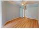 Large bedroom with light hardwood floors, a ceiling fan, and light blue walls with neutral trim at 421 Marsh Creek Rd, Venice, FL 34292
