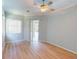 Light filled bedroom with hardwood flooring, neutral paint, and sliding doors leading to the pool area at 421 Marsh Creek Rd, Venice, FL 34292