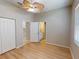 This bedroom features wood floors, closet, ensuite bathroom and tropical ceiling fan at 421 Marsh Creek Rd, Venice, FL 34292