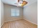 Cozy bedroom with wood flooring, ceiling fan, neutral walls, and window with blinds at 421 Marsh Creek Rd, Venice, FL 34292