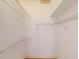 Spacious walk-in closet with lots of shelving for storage and organization at 421 Marsh Creek Rd, Venice, FL 34292