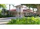 Community clubhouse with elegant architecture, landscaping, and street access at 421 Marsh Creek Rd, Venice, FL 34292