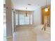 Dining area with tile floors, chandelier, and sliding glass doors leading to the outdoor space at 421 Marsh Creek Rd, Venice, FL 34292