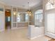Dining area featuring tile floors, neutral paint, archway, and plenty of natural light at 421 Marsh Creek Rd, Venice, FL 34292