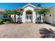 Charming home exterior with a well-maintained paver driveway and lush landscaping at 421 Marsh Creek Rd, Venice, FL 34292