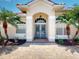 Inviting home exterior with double doors, lovely landscaping, and brick paved entrance at 421 Marsh Creek Rd, Venice, FL 34292