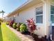 Charming side yard with well-maintained landscaping and stepping stone path at 421 Marsh Creek Rd, Venice, FL 34292