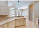 Bright kitchen with breakfast bar, stainless steel dishwasher, and an archway leading to the dining area at 421 Marsh Creek Rd, Venice, FL 34292