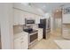 Modern kitchen featuring stainless steel appliances, light colored cabinetry, and tile backsplash at 421 Marsh Creek Rd, Venice, FL 34292