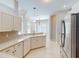 Open-concept kitchen with breakfast bar, tile backsplash, stainless steel appliances, and an adjacent breakfast nook at 421 Marsh Creek Rd, Venice, FL 34292