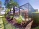 Lush landscaping surrounding screened-in pool area offering privacy and a tropical paradise at 421 Marsh Creek Rd, Venice, FL 34292