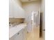 Well-equipped laundry area with machines, sink, storage, and access to other rooms at 421 Marsh Creek Rd, Venice, FL 34292