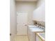 Functional laundry area featuring machines, storage cabinets, and a utility sink at 421 Marsh Creek Rd, Venice, FL 34292
