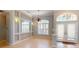 Living area featuring neutral paint, beautiful chandelier, archway, and plenty of light at 421 Marsh Creek Rd, Venice, FL 34292