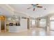 Open-concept living area with tiled flooring, neutral paint, and abundant natural light at 421 Marsh Creek Rd, Venice, FL 34292