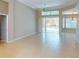 Large living room featuring tile floors, neutral paint, and a glass door leading to a pool at 421 Marsh Creek Rd, Venice, FL 34292