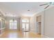 Inviting living area featuring tile floors, archway, beautiful chandelier, and neutral paint at 421 Marsh Creek Rd, Venice, FL 34292