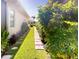 Well-maintained side yard garden offering a serene escape and enhanced curb appeal to the home at 421 Marsh Creek Rd, Venice, FL 34292