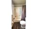 Classic bathroom with tub/shower, toilet, and dark wood-look flooring at 426 Ricold Ter, Port Charlotte, FL 33954