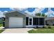 Charming single-story home with a well-maintained lawn and a one-car garage at 426 Ricold Ter, Port Charlotte, FL 33954