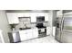Updated kitchen features stainless steel appliances, granite countertops, and white cabinets at 426 Ricold Ter, Port Charlotte, FL 33954