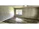 Cozy Living Room features wood-look floors and a large window that provides plenty of natural light at 426 Ricold Ter, Port Charlotte, FL 33954