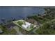 A waterfront property featuring a white metal roof, well-maintained lawn, and dock for scenic views and water activities at 4460 Northshore Dr, Punta Gorda, FL 33980
