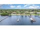 Waterfront homes featuring private docks on a sunny day, with lush green trees lining the community at 4460 Northshore Dr, Punta Gorda, FL 33980
