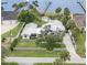 Stunning aerial view of waterfront home with pool, lush landscaping, and private docks on the river at 4460 Northshore Dr, Punta Gorda, FL 33980
