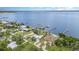 Aerial view of waterfront homes featuring private docks on a sunny day, with lush green trees at 4460 Northshore Dr, Punta Gorda, FL 33980