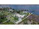 Stunning waterfront home with a white metal roof, pool, lush landscaping, and private dock for boating and waterfront enjoyment at 4460 Northshore Dr, Punta Gorda, FL 33980