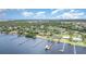 Waterfront homes featuring private docks on a sunny day, with lush green trees lining the community at 4460 Northshore Dr, Punta Gorda, FL 33980