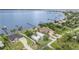 Aerial view of waterfront homes featuring private docks on a sunny day in a beautiful community at 4460 Northshore Dr, Punta Gorda, FL 33980