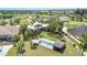 A backyard featuring a screened in gazebo and a rectangular pool surrounded by luscious grass and palms at 4460 Northshore Dr, Punta Gorda, FL 33980