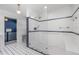 Sleek bathroom showcases glass shower and white tiling with blue accents at 4460 Northshore Dr, Punta Gorda, FL 33980