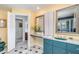 Spacious bathroom vanity featuring granite countertops, blue cabinets, and yellow walls providing an open airy feel at 4460 Northshore Dr, Punta Gorda, FL 33980