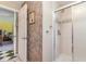 Bathroom featuring an open door with tiled walls leading to a shower and a view of a bedroom nearby at 4460 Northshore Dr, Punta Gorda, FL 33980
