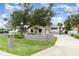 Charming home with stone accents, mature trees, and a well-maintained lawn for great outdoor living at 4460 Northshore Dr, Punta Gorda, FL 33980