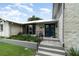 Inviting front entrance with a new metal roof, stone facade, and meticulously landscaped garden beds at 4460 Northshore Dr, Punta Gorda, FL 33980