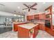 Spacious kitchen island with cherry cabinets and granite countertops, perfect for cooking and gatherings at 4460 Northshore Dr, Punta Gorda, FL 33980