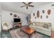 Inviting living room with a television, comfortable seating, and unique wall decor for a cozy atmosphere at 4460 Northshore Dr, Punta Gorda, FL 33980