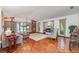Spacious living room with hardwood floors, large windows, fireplace, and built-in bookshelves at 4460 Northshore Dr, Punta Gorda, FL 33980