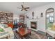 Cozy living room with a fireplace, vaulted ceiling, and built-in bookshelves perfect for relaxing at 4460 Northshore Dr, Punta Gorda, FL 33980