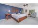Comfortable main bedroom features a king bed, unique accent wall, and ample natural light at 4460 Northshore Dr, Punta Gorda, FL 33980