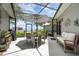 Enjoy outdoor dining on this screened patio with views of the lake at 4460 Northshore Dr, Punta Gorda, FL 33980