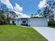 Charming single-story home featuring a well-manicured lawn and an attached two-car garage at 8530 Sawyer Cir, North Port, FL 34288