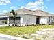 Charming single-story home features a well-manicured lawn, two-car garage, and neutral stucco exterior at 8706 Seasalt Loop, Englewood, FL 34224