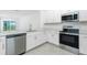 Modern kitchen with stainless steel appliances, stone countertops and white cabinets at 8706 Seasalt Loop, Englewood, FL 34224